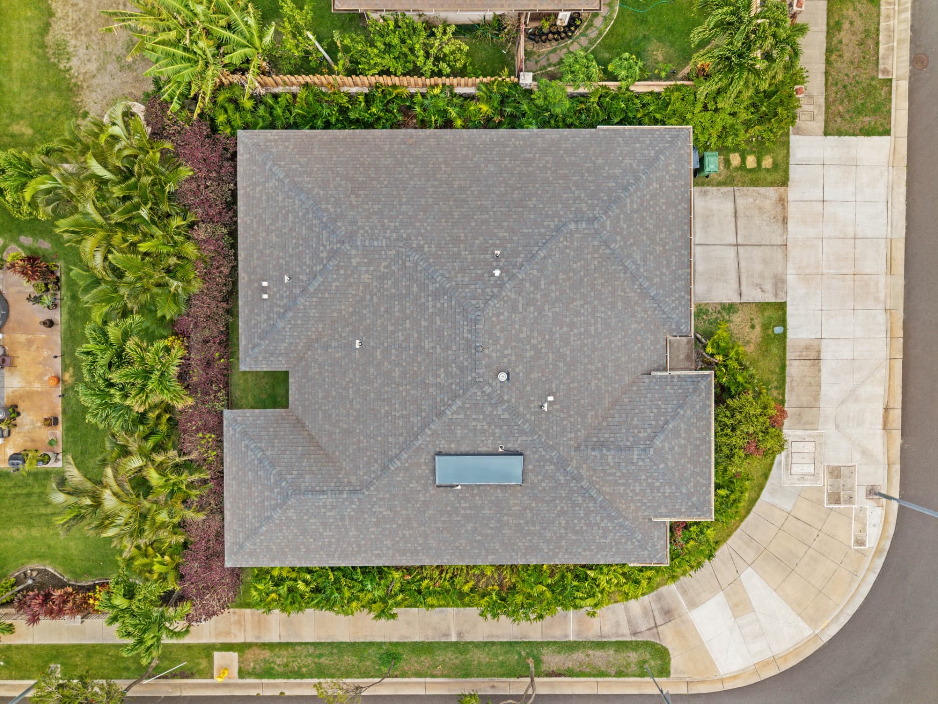 Overhead aerial view showing the roof, solar water heater panels and corner lot landscaping