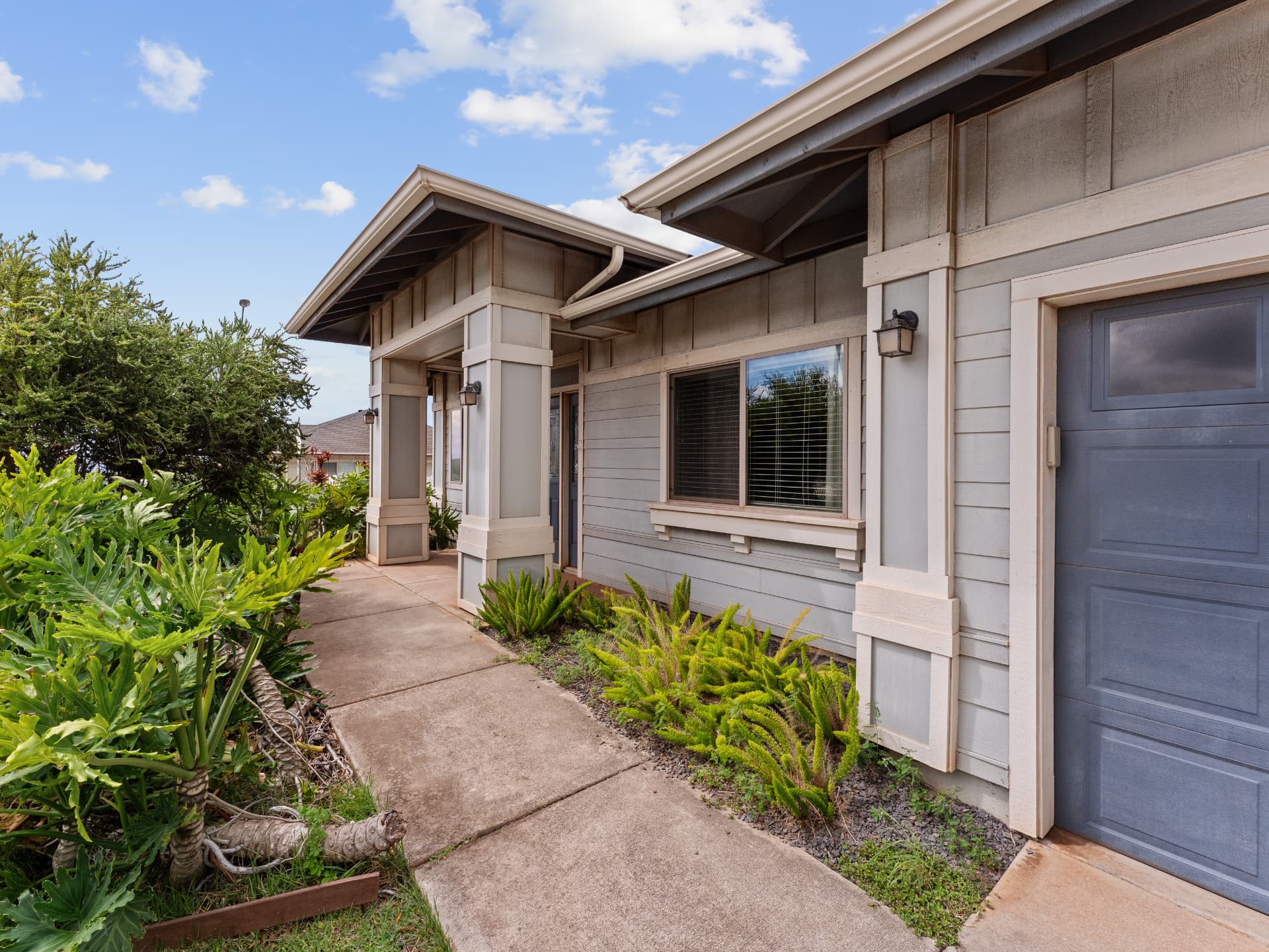 Walkway leading to the covered front porch and garage entry