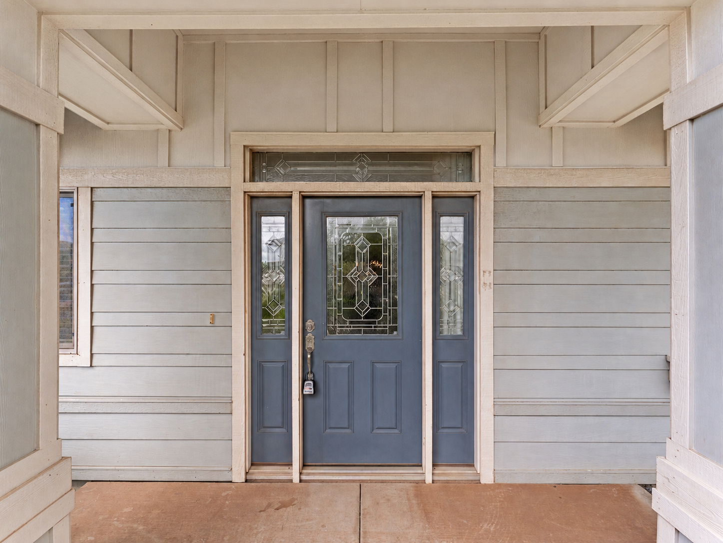 Covered front porch with decorative glass entry door